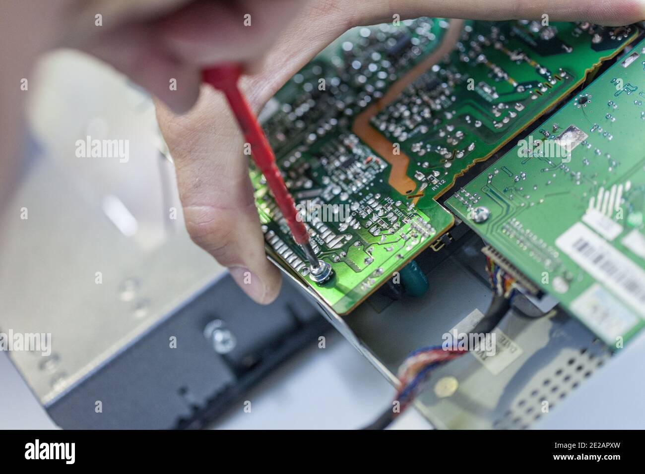 Closeup shot of a person's hand working on a motherboard Stock Photo ...