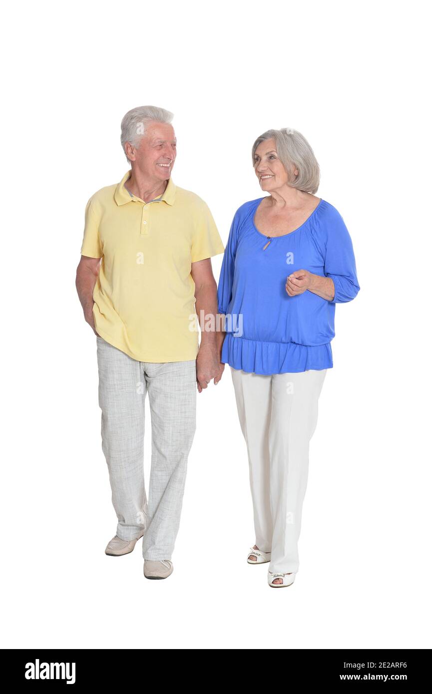 Full length portrait of senior couple holding hands isolated on white ...