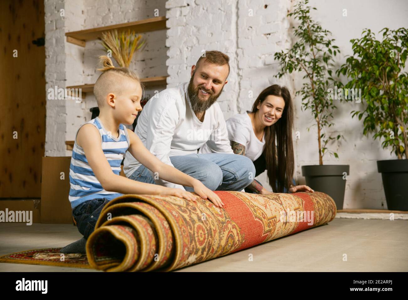Picture of Young couple, family doing apartment repair together themselves. Mother ...