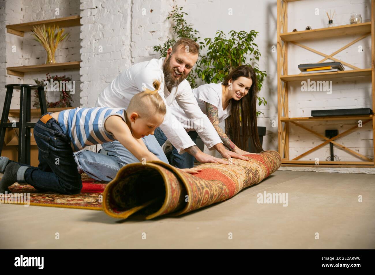 View of Young couple, family doing apartment repair together themselves. Mother ...