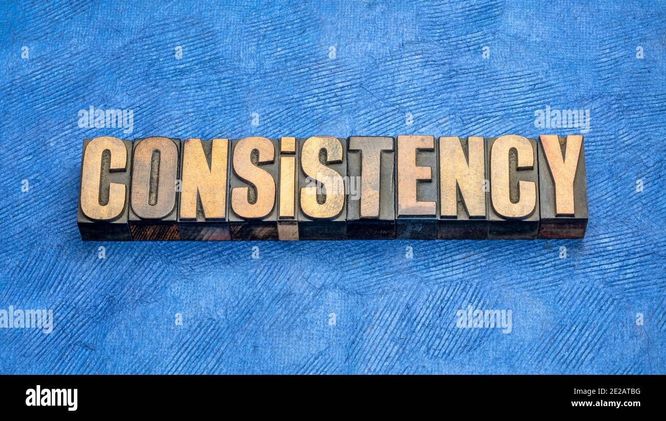 consistency word abstract in vintage letterpress wood type against handmade paper Stock Photo