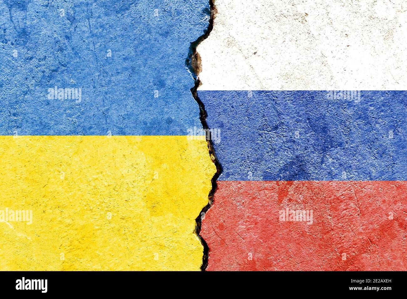 View of Ukraine vs Russia flags on cracked concrete wall - political partnership conflicts concept Stock Photo
