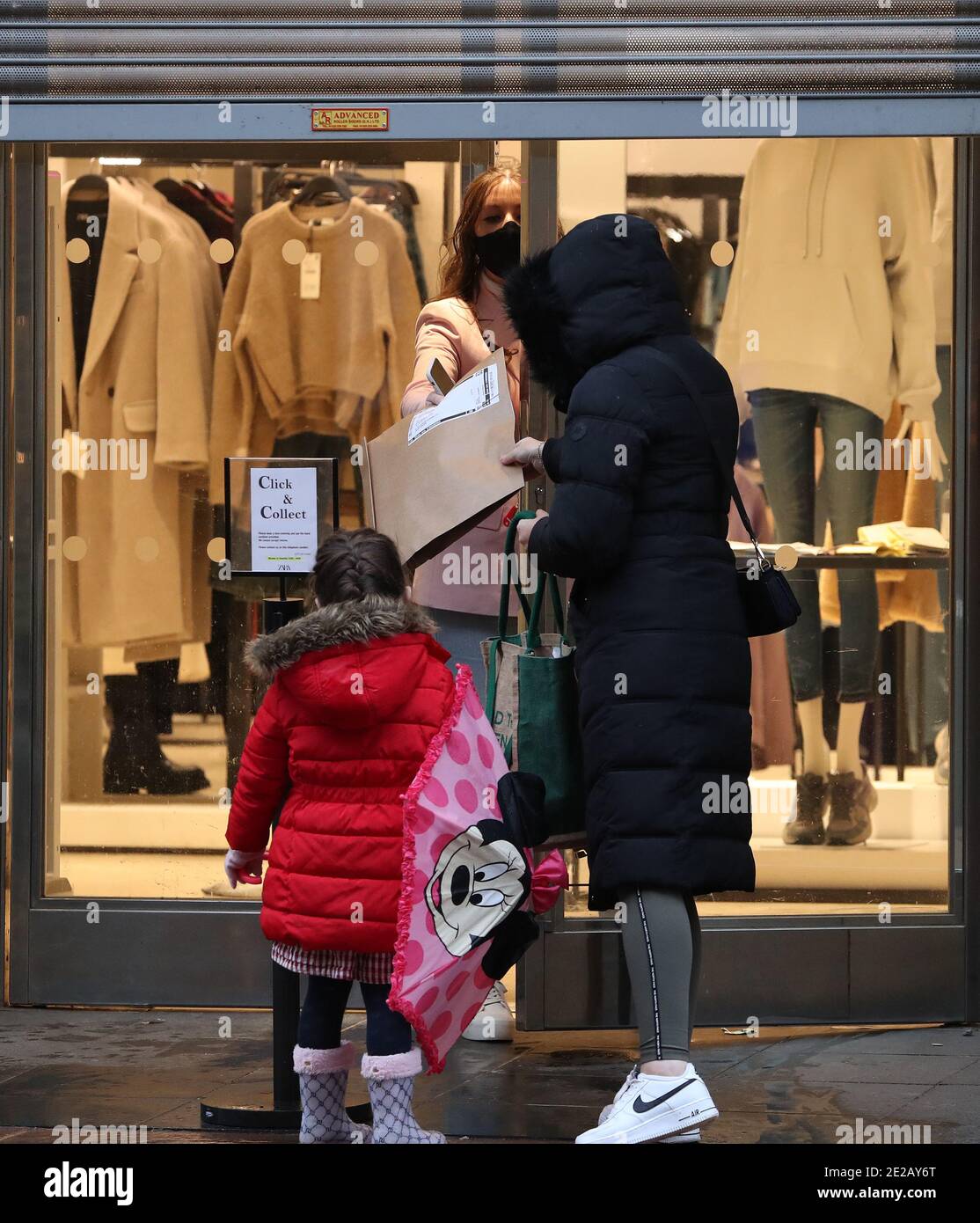 A person collects a parcel from Zara in Glasgow. Click-and-collect services  will end in Scotland, First Minister Nicola Sturgeon has said, Only  retailers selling essentials, such as clothing, baby equipment and books,