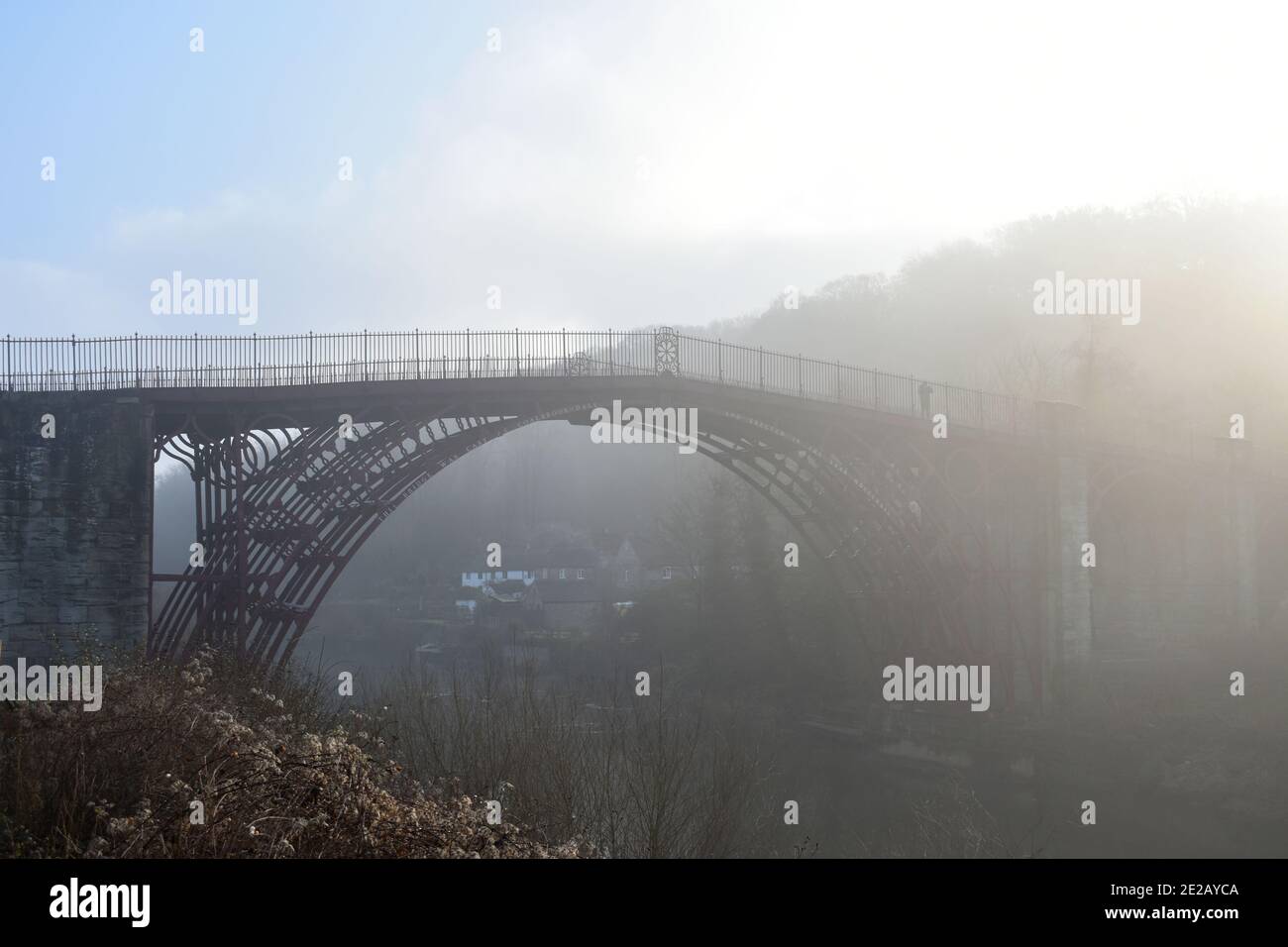 The Ironbridge, Shropshire, UK on a misty morning spanning the river severn.  The bridge is enveloped in fog giving an eeriness on a winter day Stock Photo