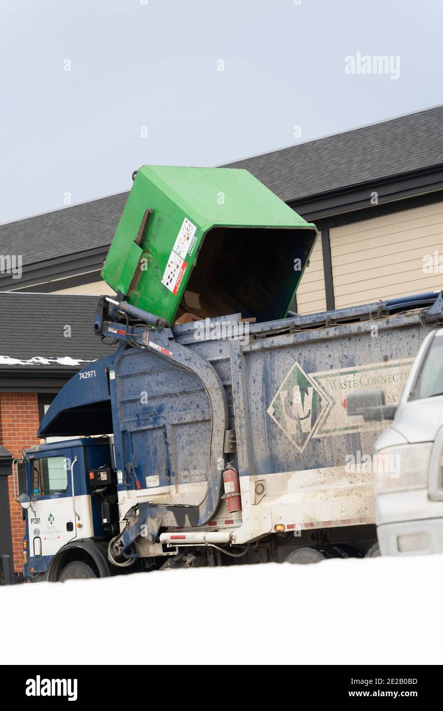 Garbage dump Truck Emptying filled Bin behind strip mall Stock Photo Alamy