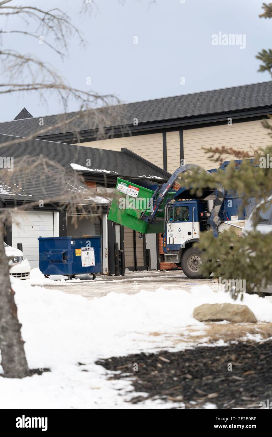 Garbage dump Truck Emptying filled Bin behind strip mall Stock Photo Alamy
