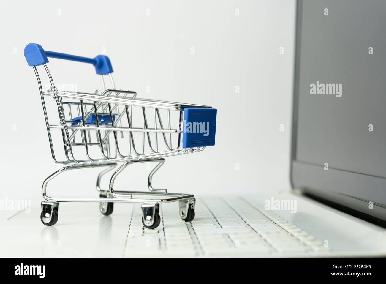 Shopping cart trolley empty on laptop keyboard.E-commerce and spend money concept.Online shopping Mock up banner template with copy space.. Stock Photo