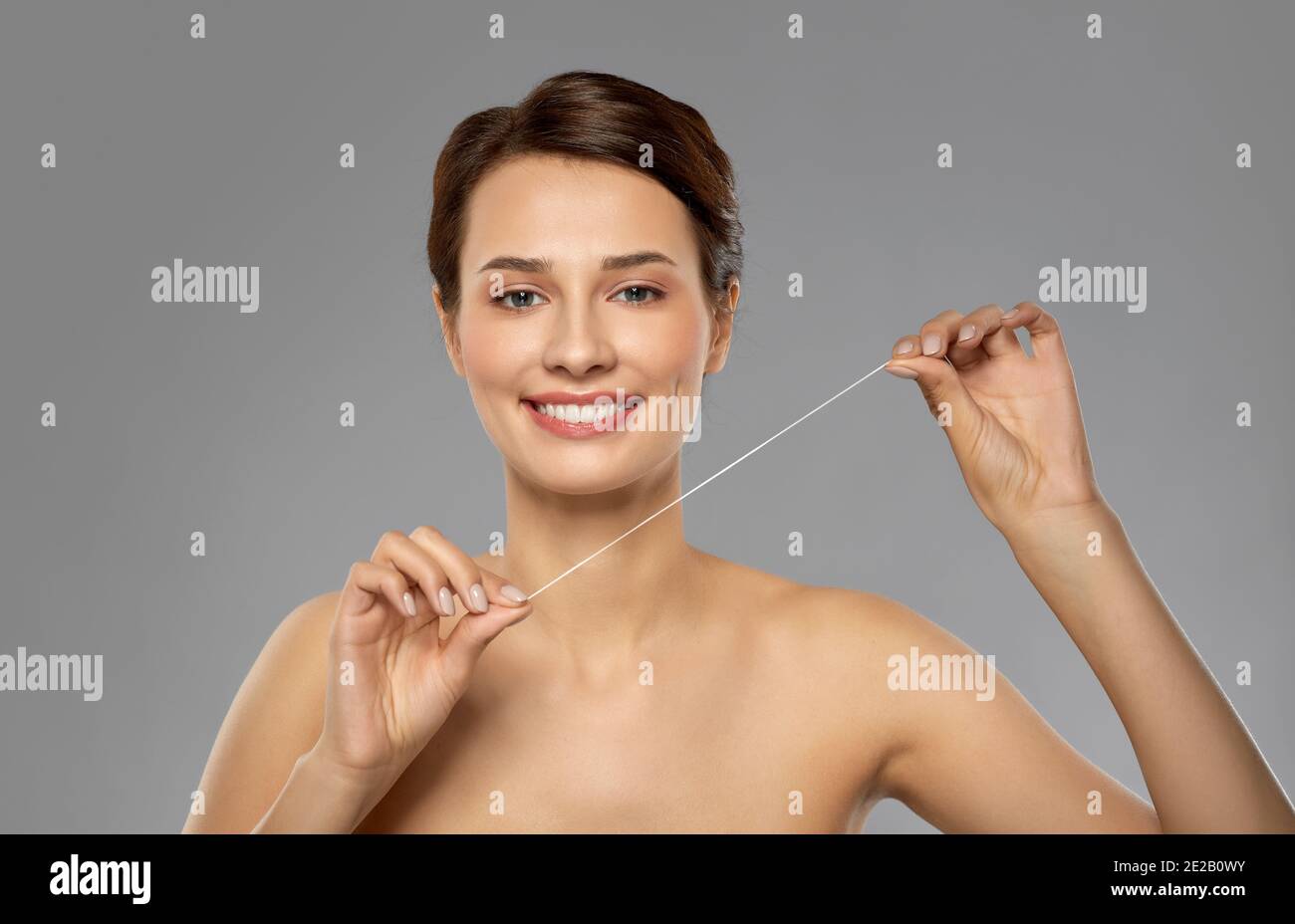 happy young woman with dental floss cleaning teeth Stock Photo Alamy