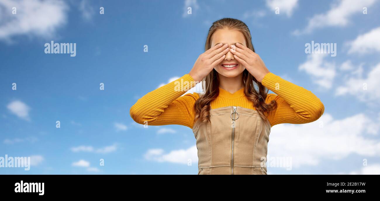 smiling teenage girl closing her eyes over sky Stock Photo
