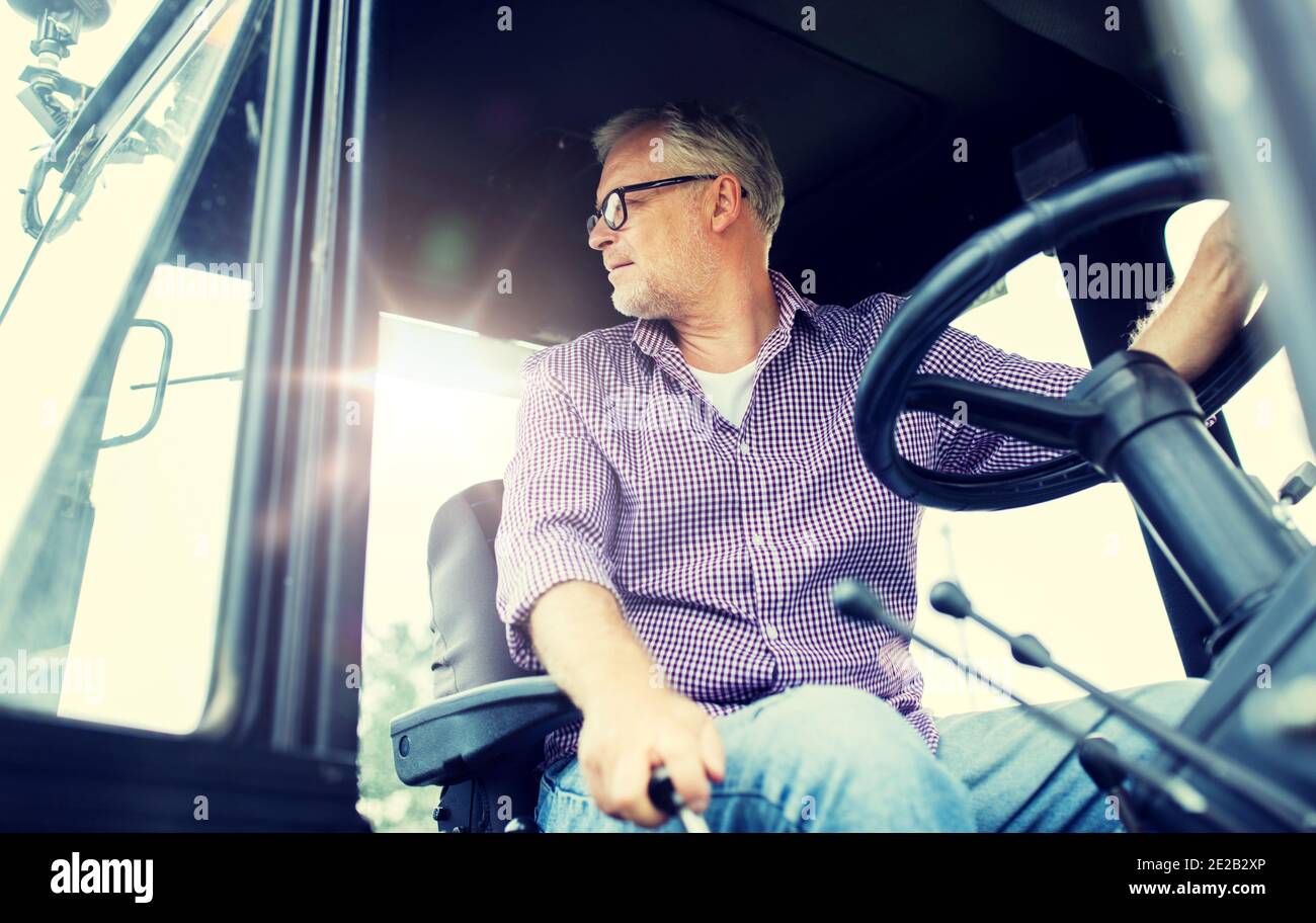 Old man driving tractor in hi-res stock photography and images - Alamy