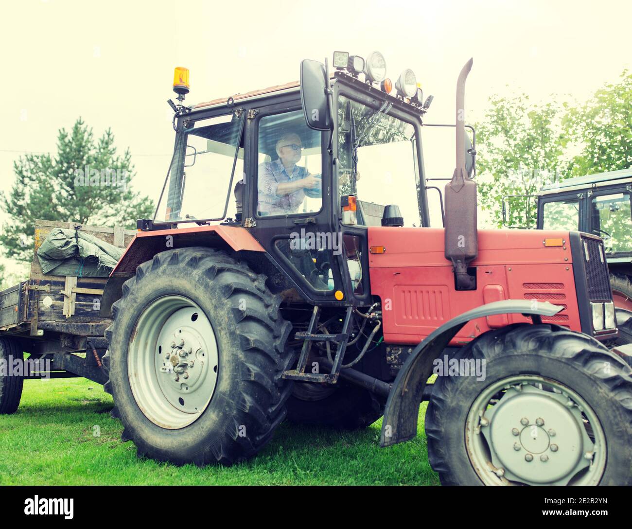 Old man driving tractor hi-res stock photography and images - Alamy