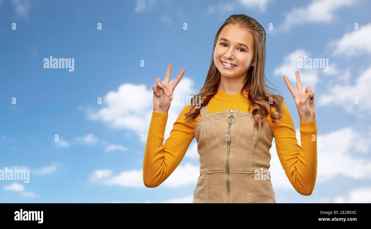 smiling young teenage girl showing peace hand sign Stock Photo - Alamy