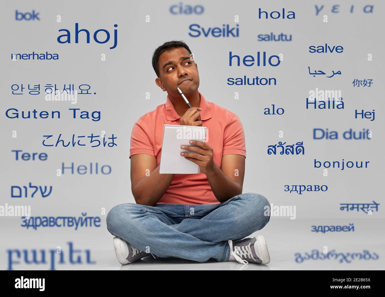 indian man in polo shirt with notebook and pen Stock Photo