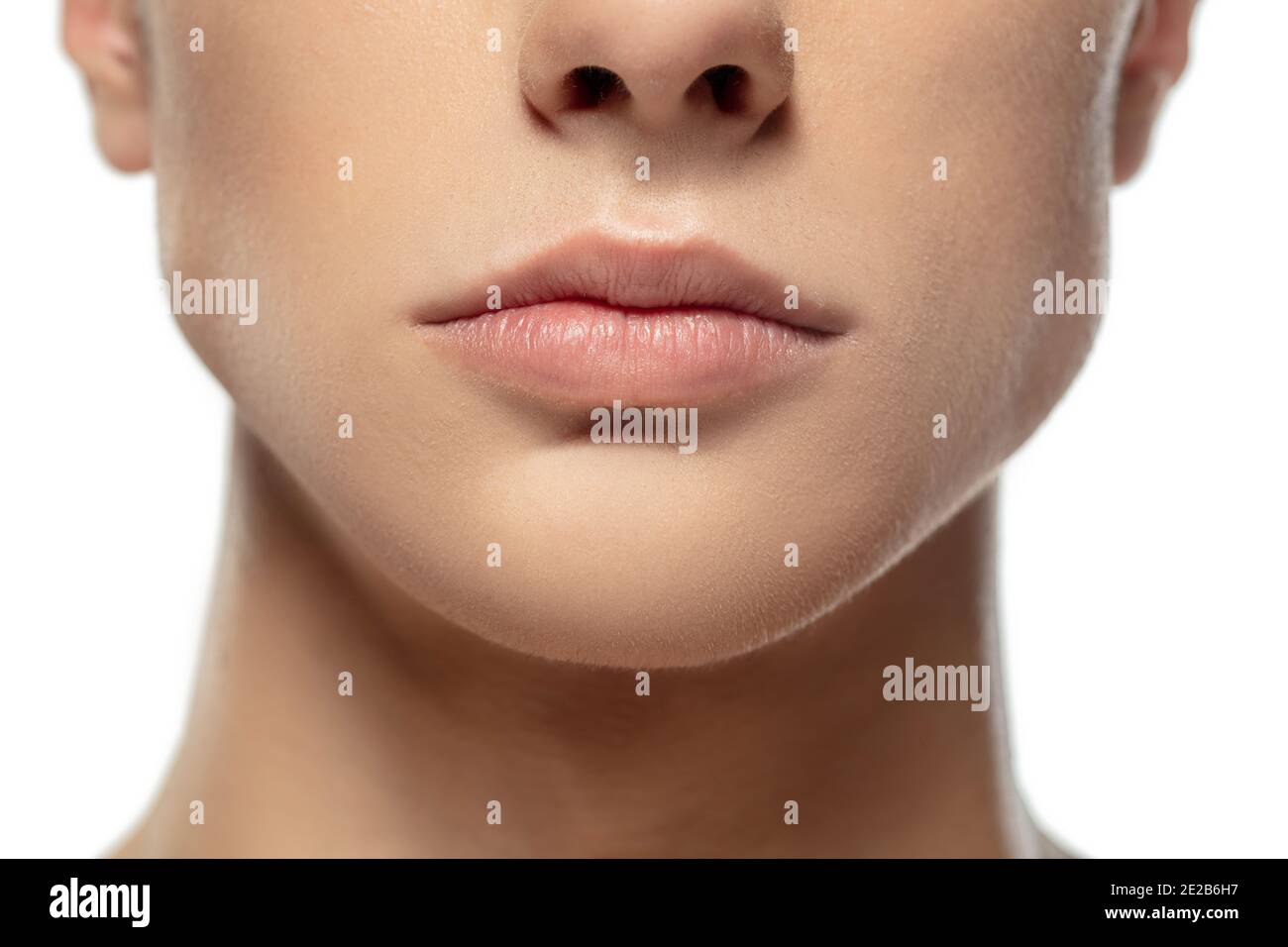 Lips. Close up face of young man isolated on white studio background
