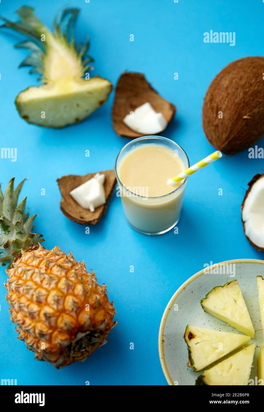 pineapple, coconut and drink with paper straw Stock Photo Alamy