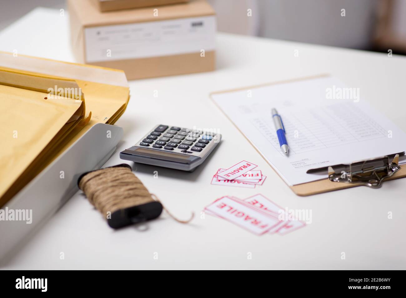calculator, clipboard and envelopes at post office Stock Photo