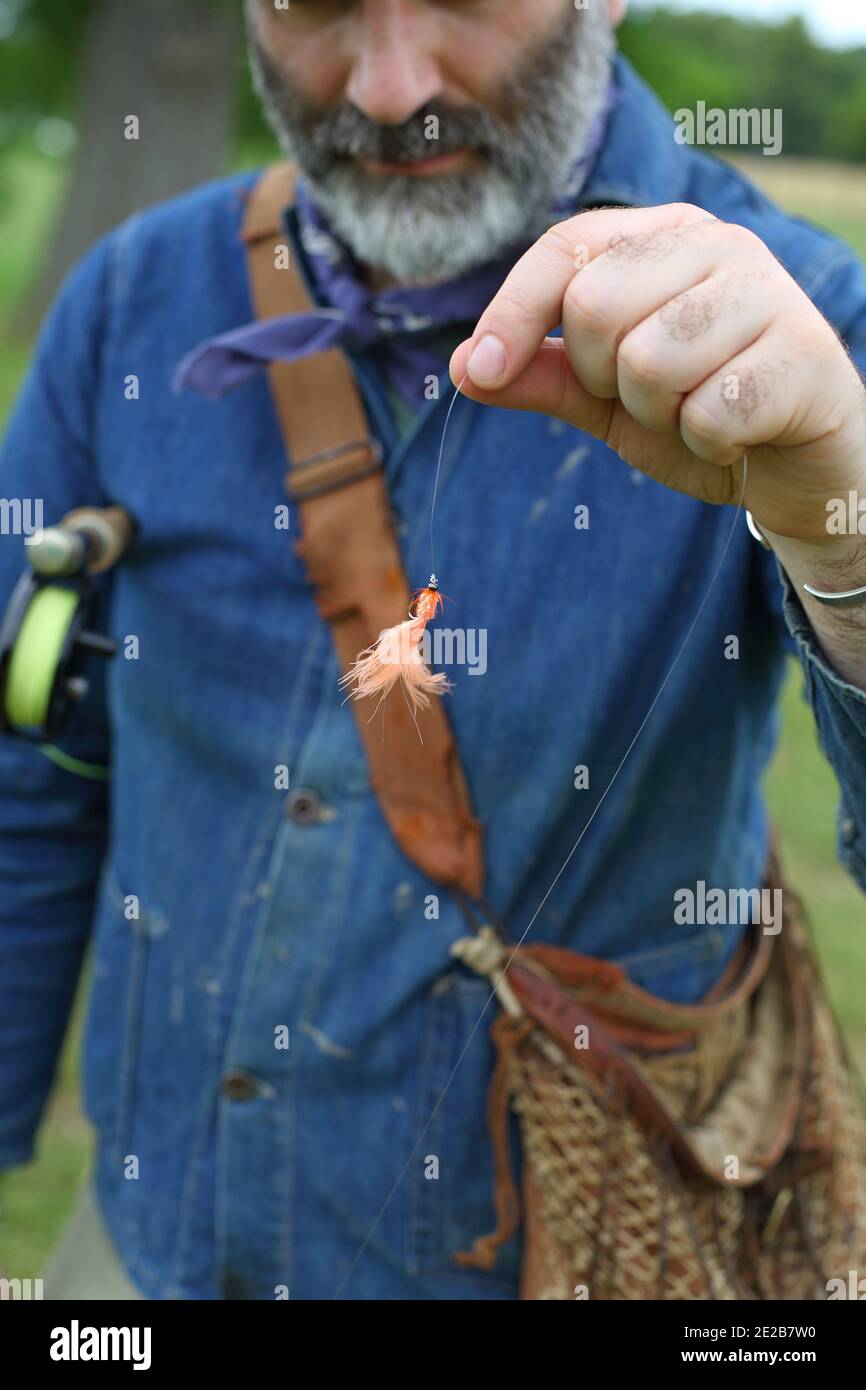 Fly Fishing Flies/ A man fly fishing ,setting up the fly rod attaching
