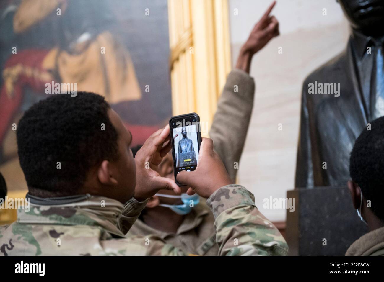 Members of the National Guard take photos of the statue of Martin Luther King Jr., in the Rotunda at the U.S. capitol, as the House of Representatives vote on H. Res. 24, Impeaching Donald John Trump, President of the United States, for high crimes and misdemeanors, at the U.S. Capitol in Washington, DC, Wednesday, January 13, 2021. Credit: Rod Lamkey/CNP | usage worldwide Stock Photo