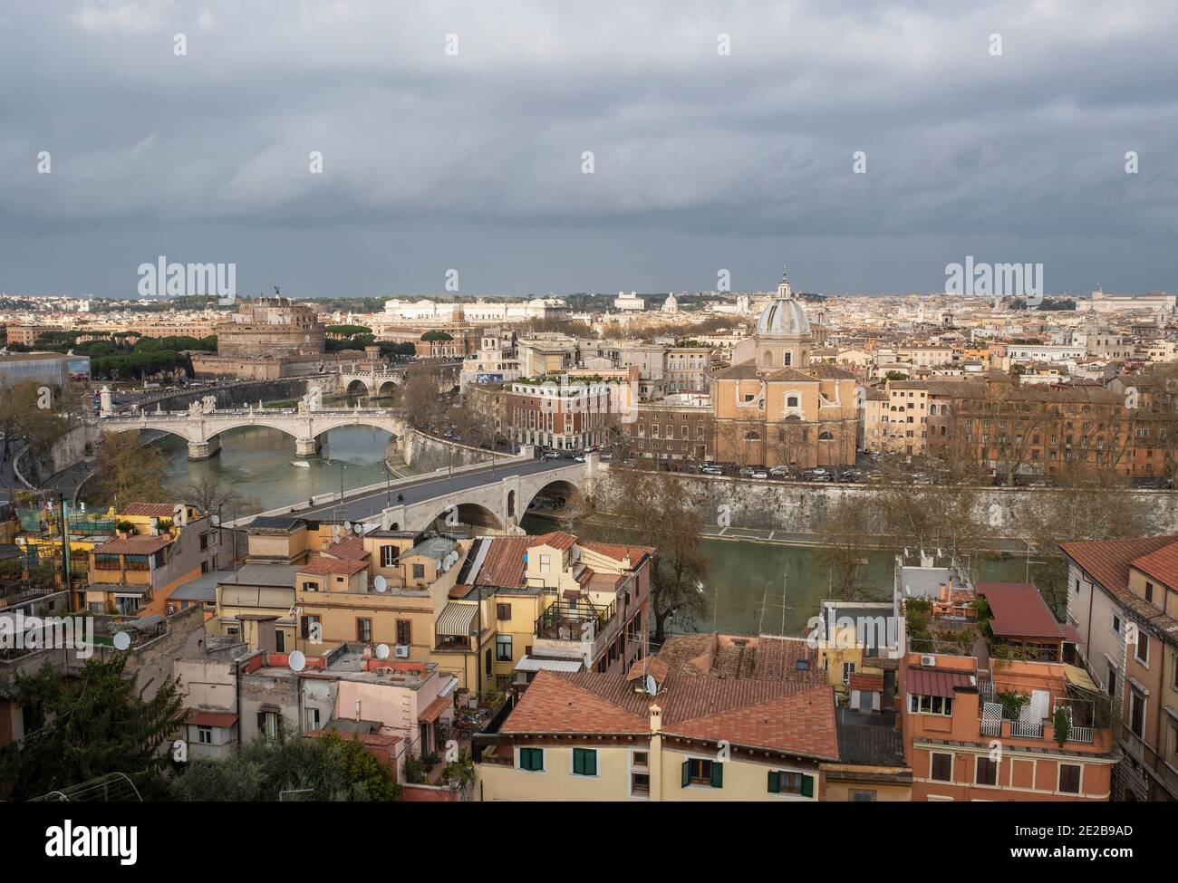 View across the River Tiber and bridges to central Rome from Trastevere. The Church of San Giovanni Battista dei Fiorentini on the riverbank. Stock Photo
