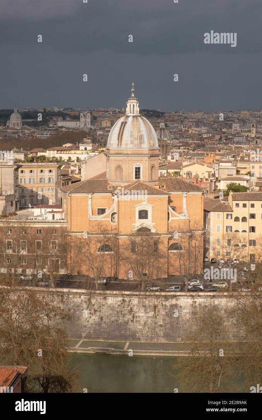 View from Trastevere over the River Tiber to central Rome, Italy. Church of San Giovanni Battista dei Fiorentini on the riverbank. Stock Photo
