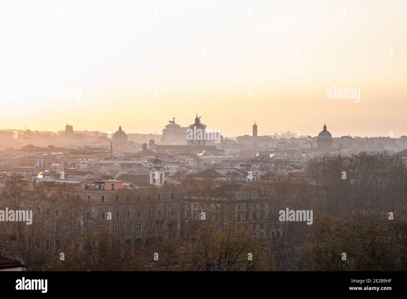 Skyline view of Rome, Italy, from Trastevere at sunrise. Famous landmarks include Vittorio Emanuele Monument and Church of Sant' Andrea della Valle Stock Photo