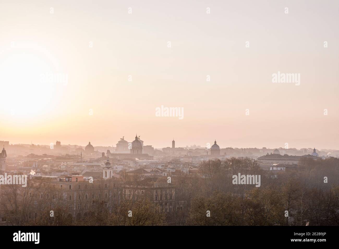 Skyline view of Rome, Italy, from Trastevere at sunrise. Famous landmarks and domes outlined in silhouette. Stock Photo