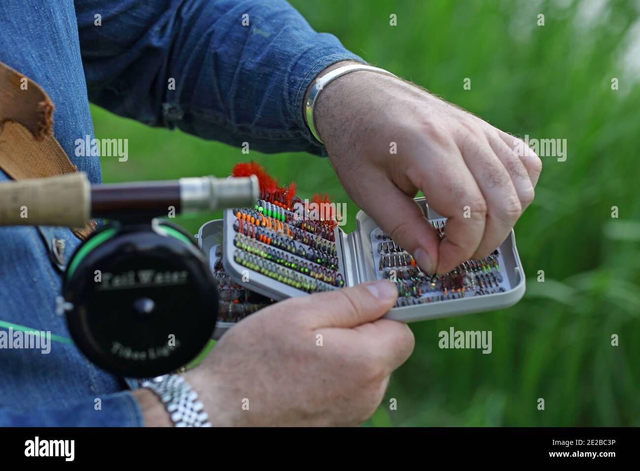 Fly Fishing Flies/ A man fly fishing ,setting up the fly rod attaching the fly Stock Photo Alamy