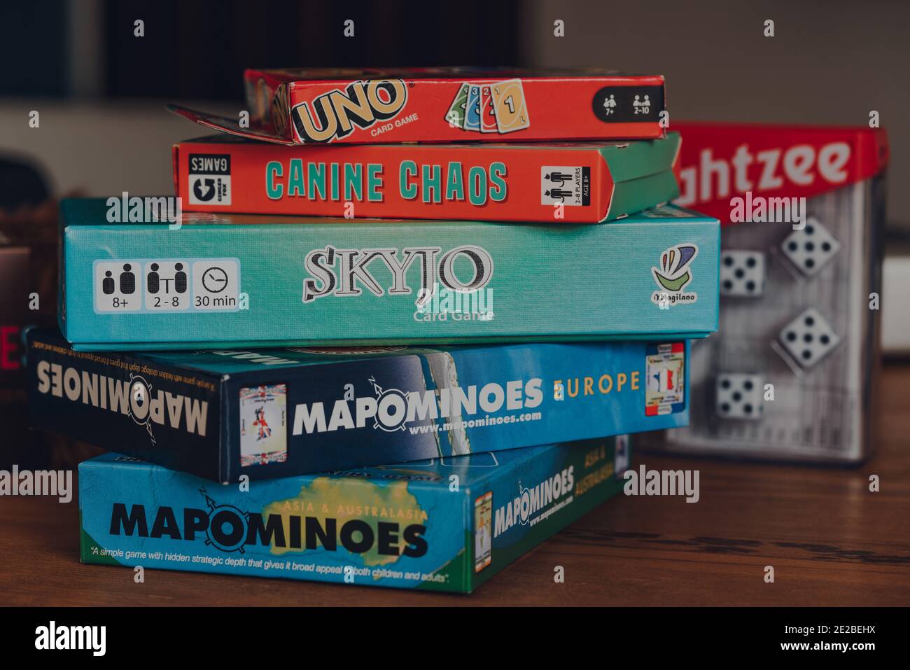 Combe St Nicholas, UK - July 25, 2020: Stack of modern and classing board games on a table. Sales of board games skyrocketed during the Coronavirus pa Stock Photo