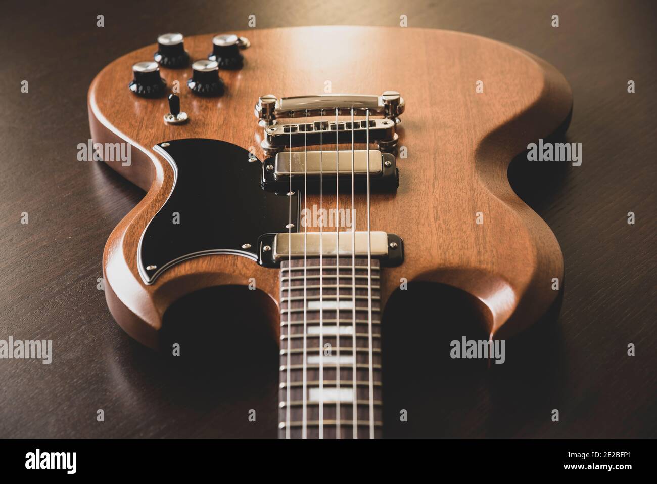 Gibson SG electric guitar on a wooden background Stock Photo