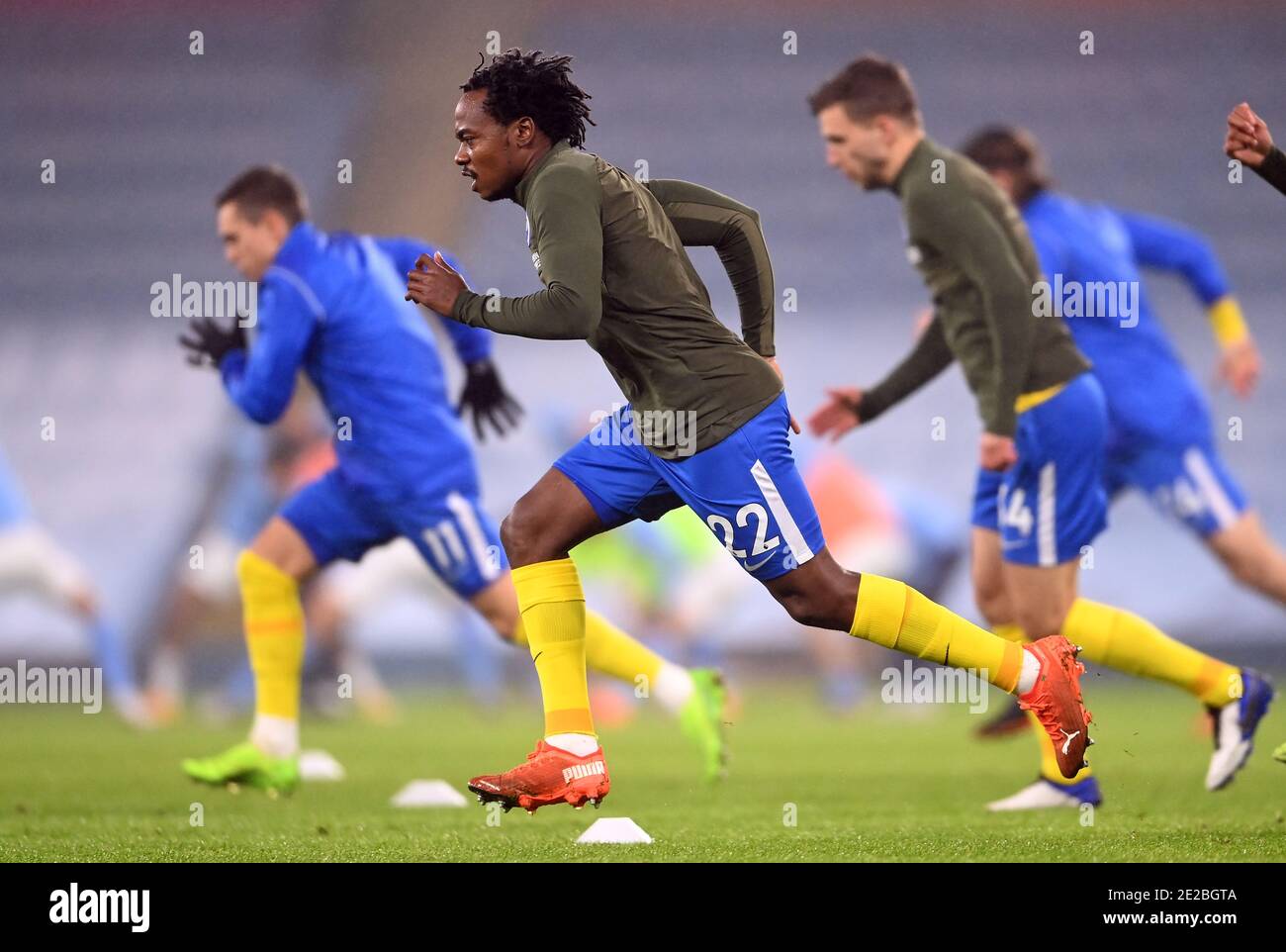 Brighton and Hove Albion's Percy Tau (no.22) and his team-mates warm up before the Premier League match at the Etihad Stadium, Manchester. Picture date: Wednesday January 13, 2021. Stock Photo