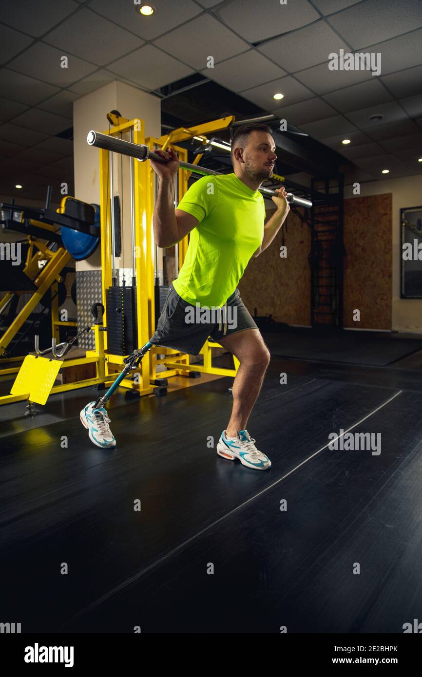 Sit ups. Disabled man training in the gym of rehabilitation center