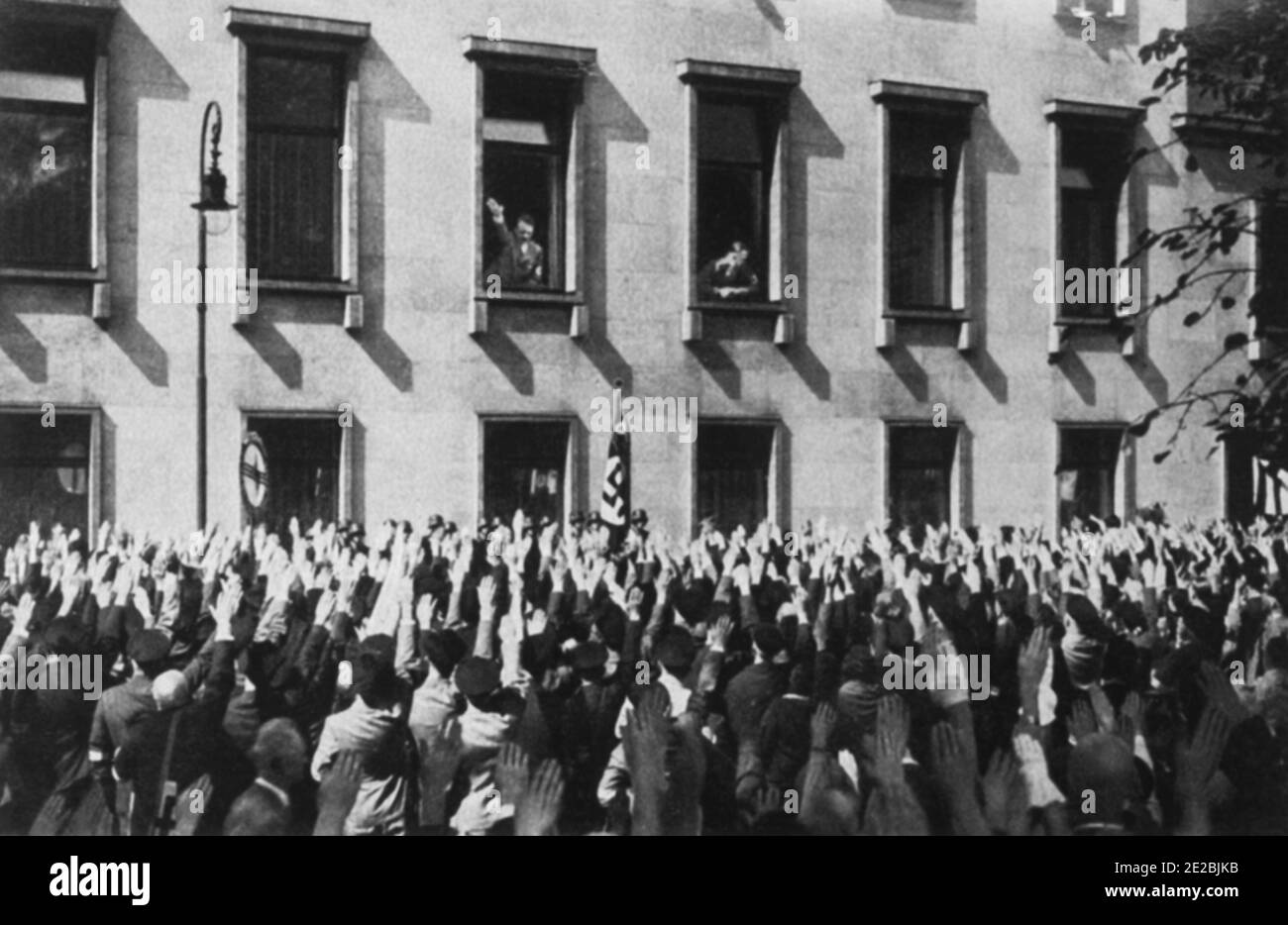 Hitler saluting the crowd from the Reich Chancellery after the Saar was reunified with Germany. Stock Photo