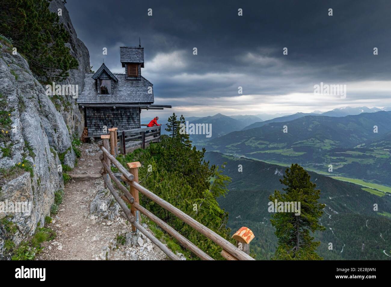 Tourist at the small Friedenskircherl / Peace Chapel looking over valley at Stoderzinken, Gröbming, district of Liezen in Styria / Steiermark, Austria Stock Photo
