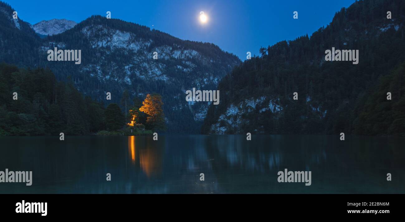 Königssee Obersee during night time with moonshine moon, harbor ship, oldtown bavaria germany Stock Photo