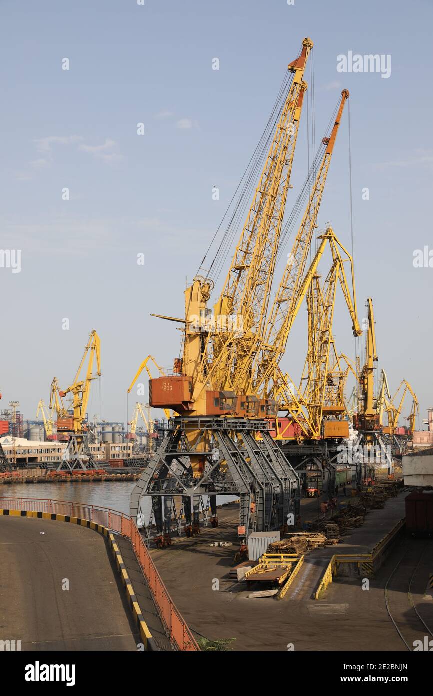 A row of yellow harbor cranes in the port of Odessa, Ukraine, at the Black Sea. Stock Photo