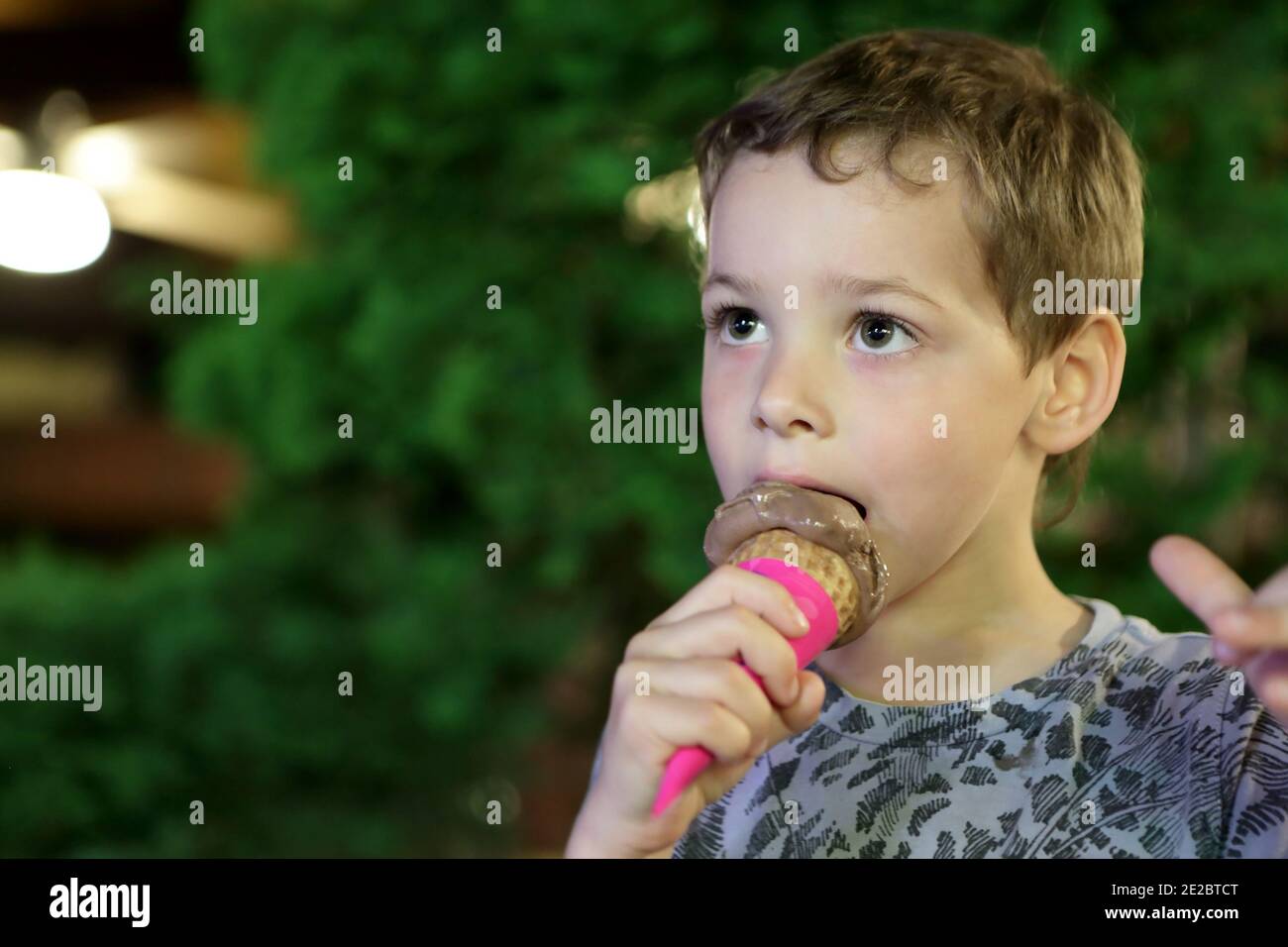 Kid eating ice cream in park at night Stock Photo Alamy