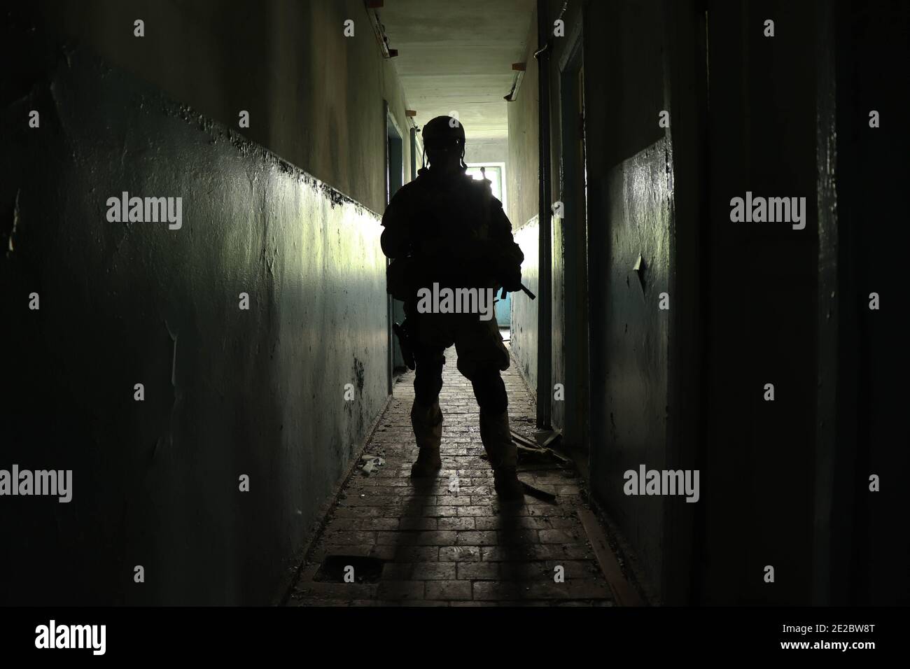a man in an abandoned building in a military uniform Stock Photo