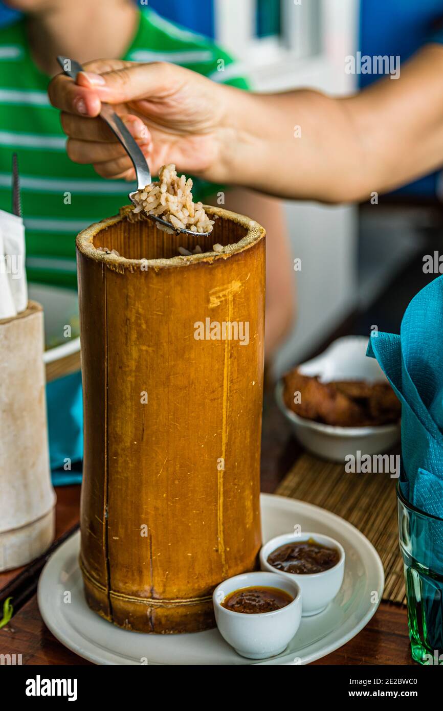 Local dish from the Caribbean island of Grenada. Rice is served in a bamboo cane. Saint George's, Grenada Stock Photo