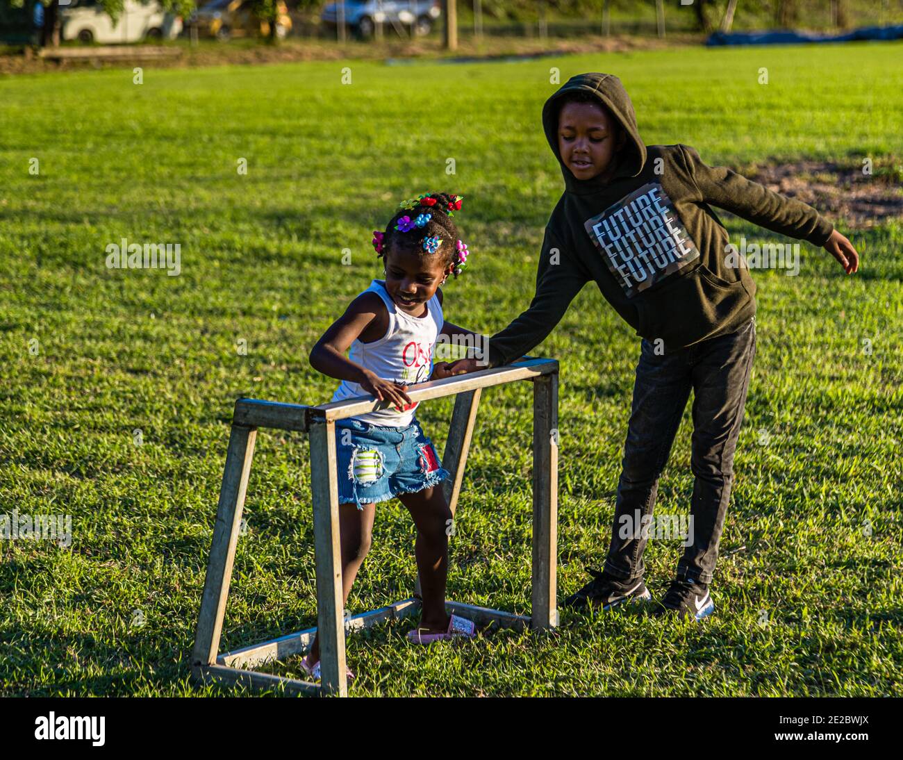 Children playing on a sports field in Grenada Stock Photo