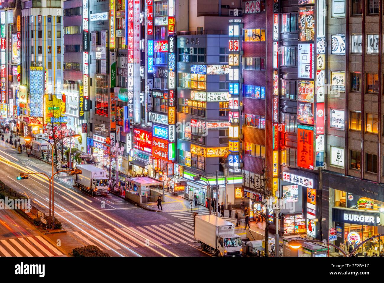 TOKYO, JAPAN - MARCH 20, 2014: Shinjuku are near Kabukicho overlooking Yasukuni-dori Street with numerous illuminated street sings. Stock Photo