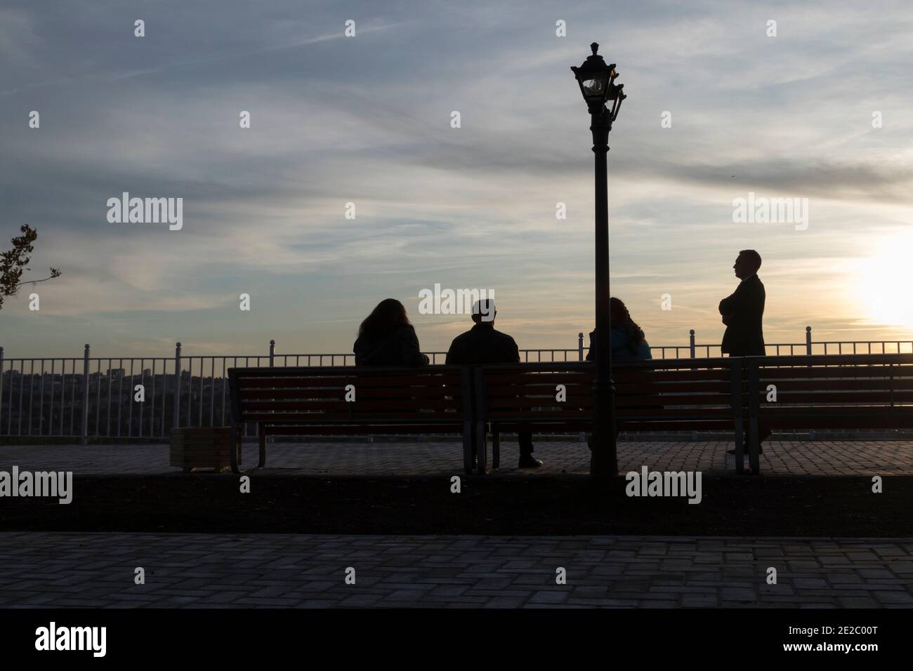 Charming sunset on the observation deck in the park. The story of one bench. Stock Photo