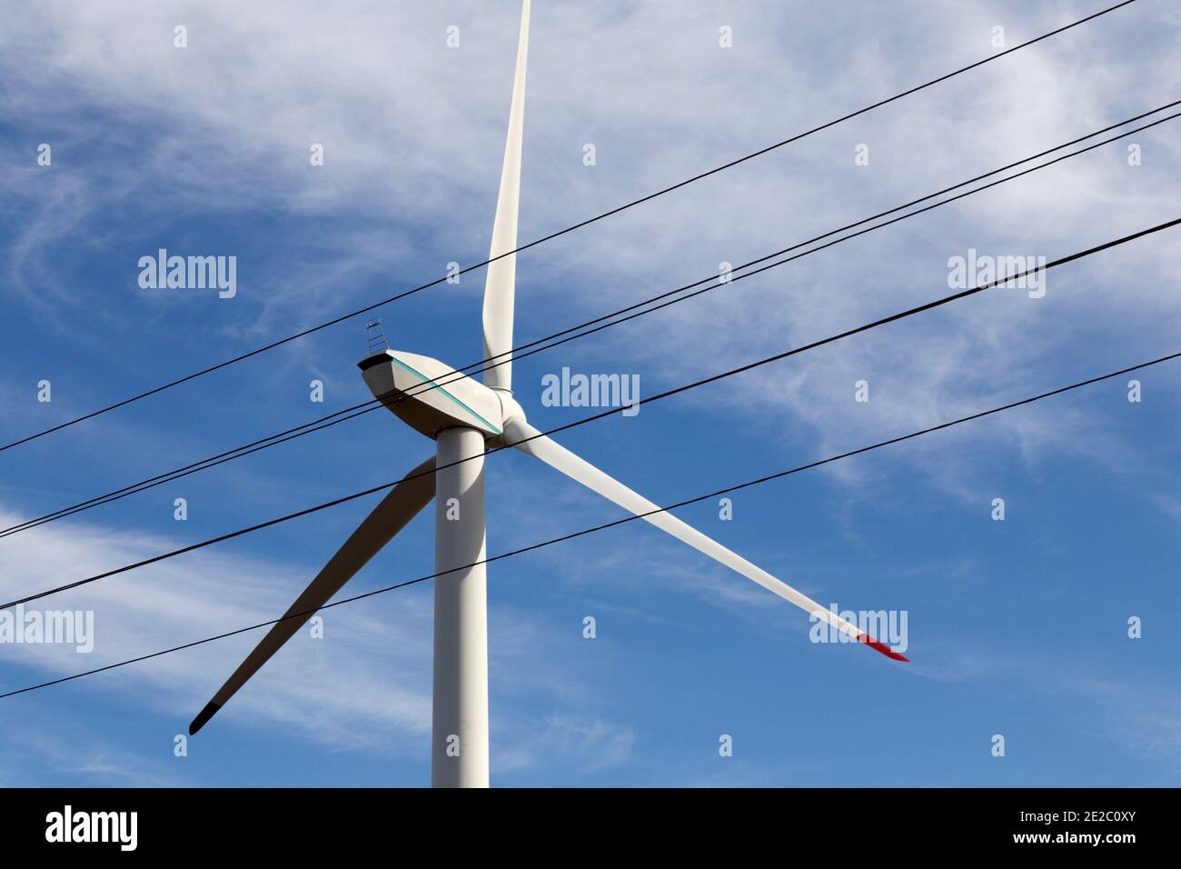 High voltage power line against the background of a wind generator. Sky ...