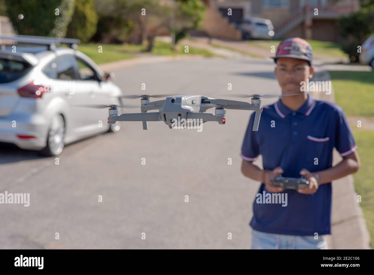 Portrait of teenager flying a drone Stock Photo