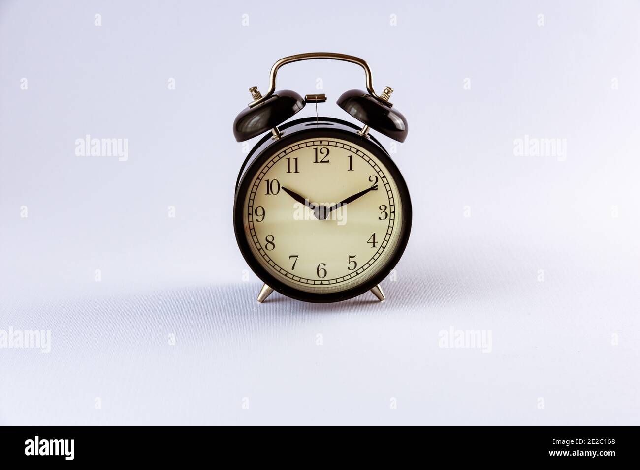 Closeup of a vintage alarm clock isolated on white background Stock ...