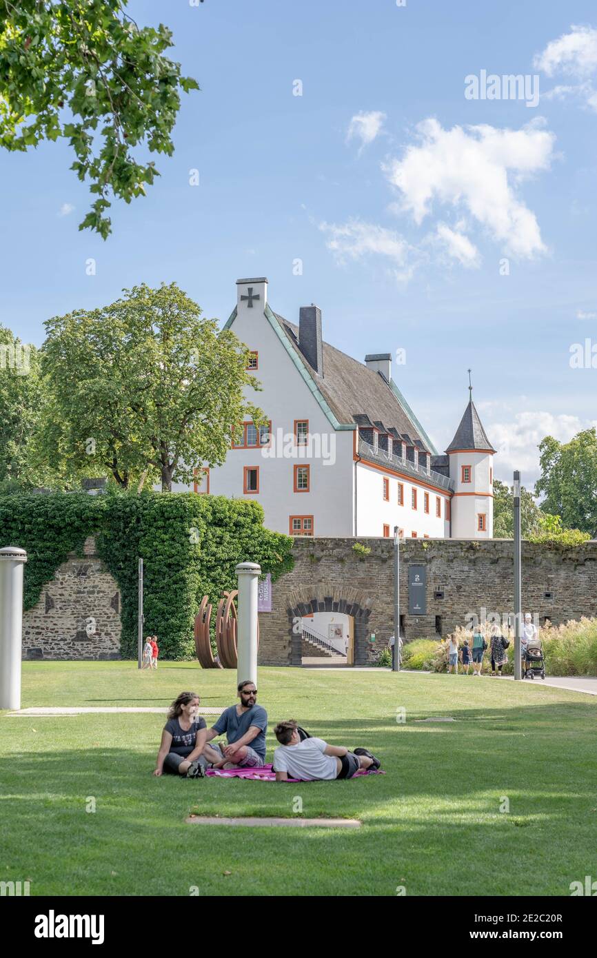Koblenz, Germany - Aug 1, 2020: People relax on lawn in park at summer noon Stock Photo