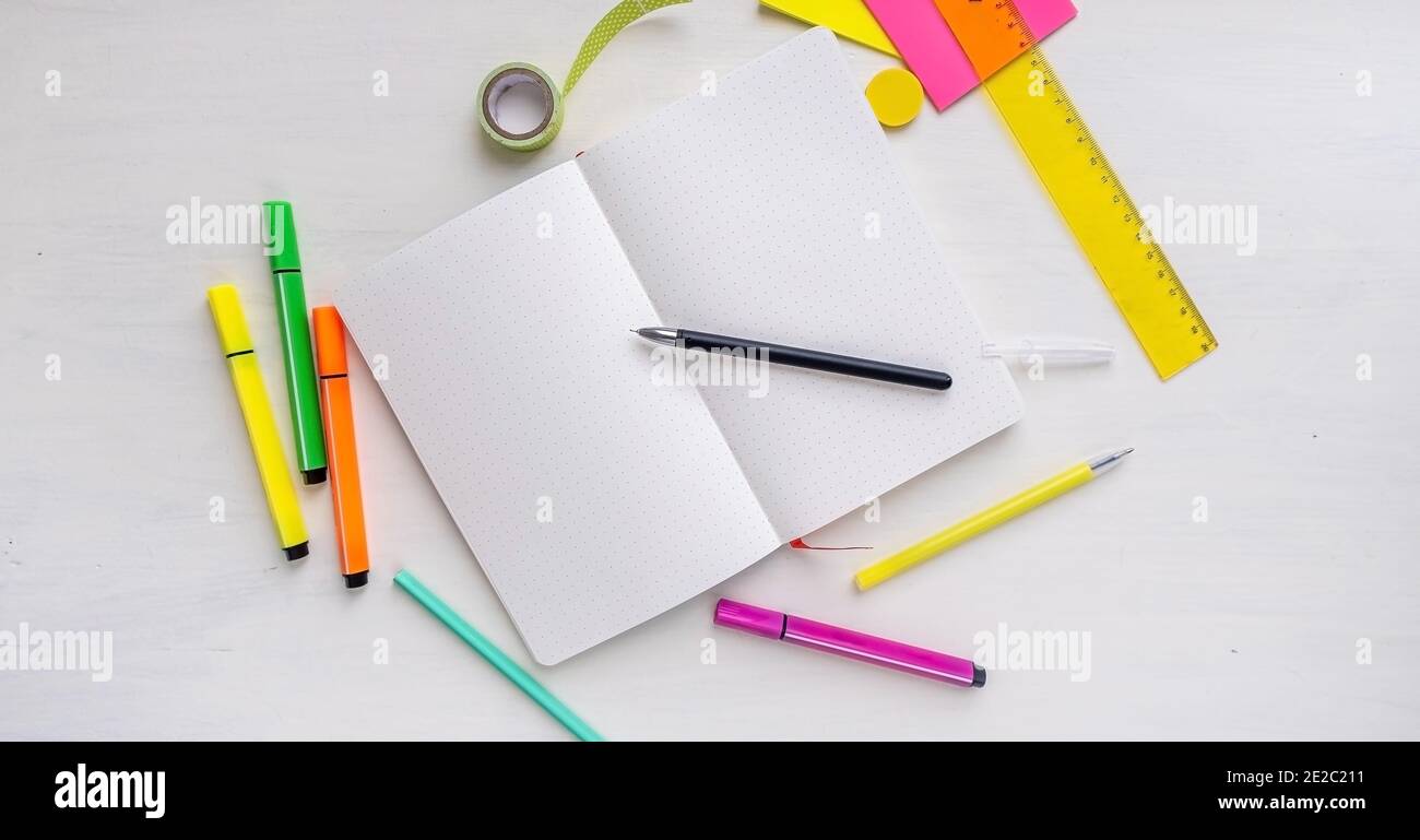Open blank bullet journal planner with dotted pages with a pen. Concept for New Years Resolutions, planning and organization Stock Photo