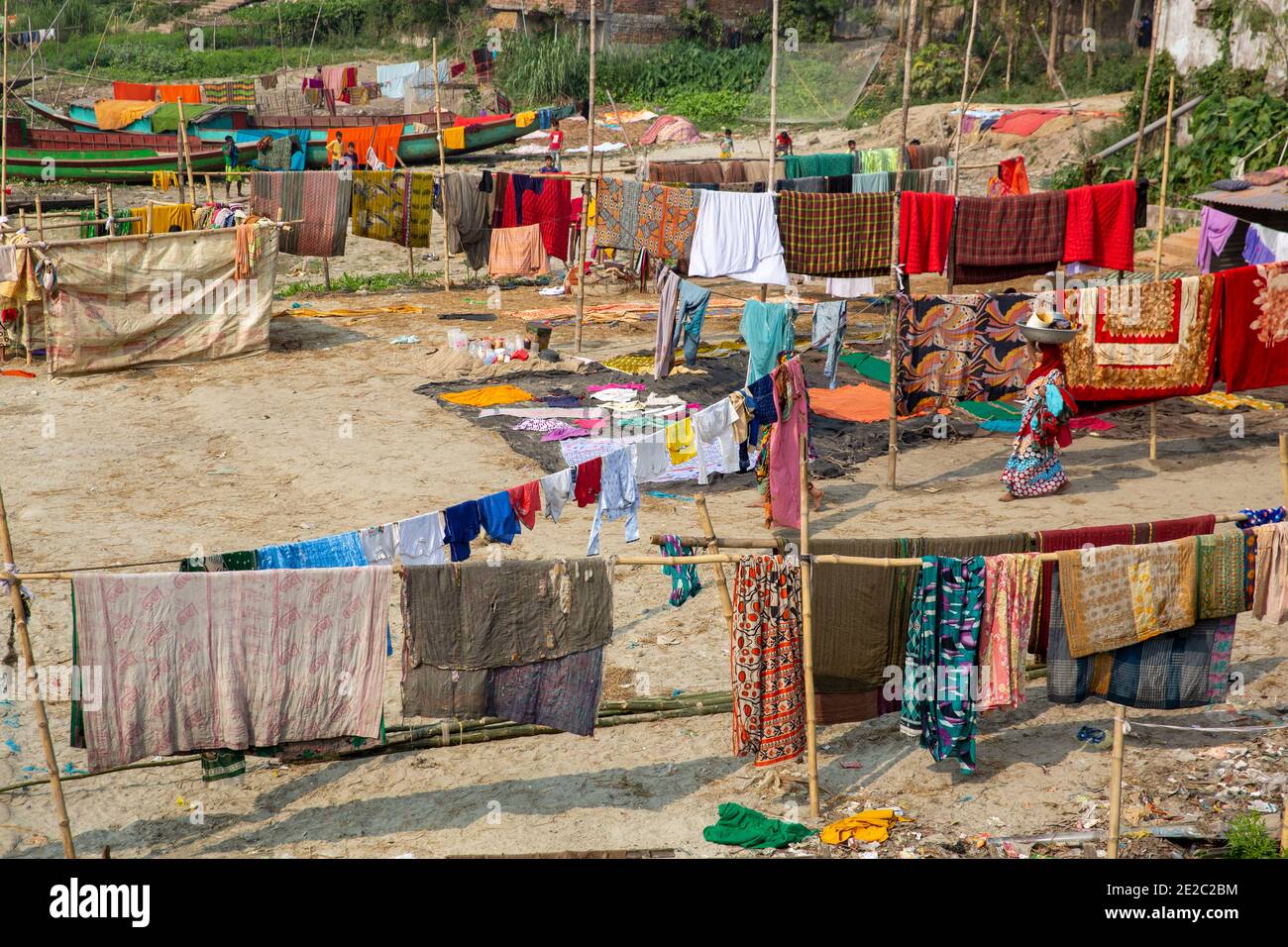 drying cloths on the bank of Titas River at Brahmanbaria, Bangladesh. Stock Photo
