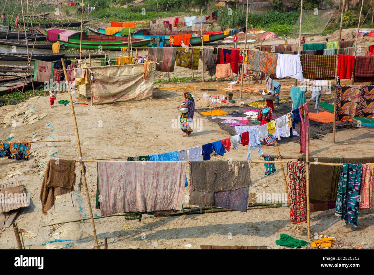 drying cloths on the bank of Titas River at Brahmanbaria, Bangladesh. Stock Photo
