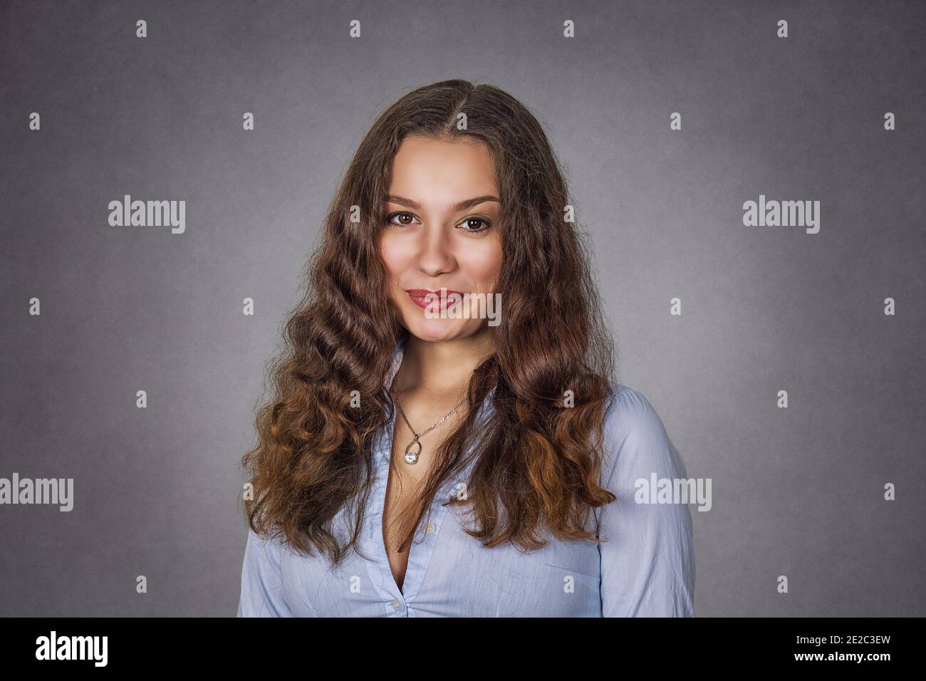 Portrait of a cute attractive young woman on gray background Stock Photo