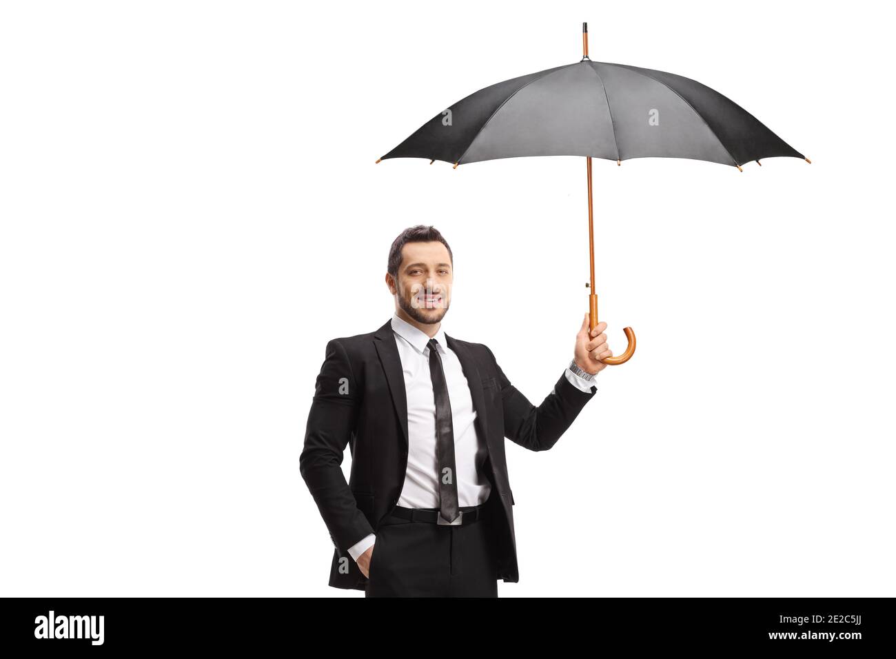 Man in suit and tie holding an umbrella isolated on white background